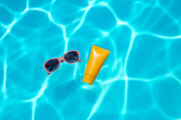 Floating sunglasses and sunscreen on turquoise pool water, minimalist summer aesthetic, product photography