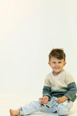 Happy caucasian children posing and playing in commercial studio with copy space
