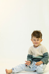 Happy caucasian children posing and playing in commercial studio with copy space