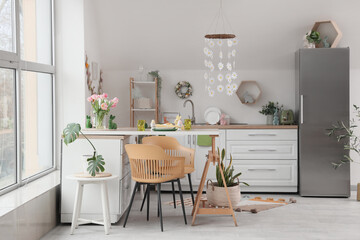 Interior of kitchen decorated for Easter with dining table and counters