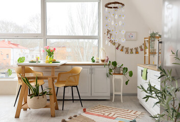 Interior of kitchen decorated for Easter with dining table and counters