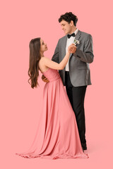 Pretty prom couple dancing valse on pink background © Pixel-Shot