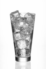 Carbonated drink with ice on a white background. Sparkling water glass and ice cubes with bubbles on a white background, refreshment. Black and white toned image.No AI, real image, shot on a camera.