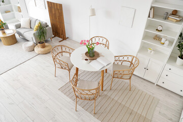 Interior of modern studio apartment with dining table and sofa