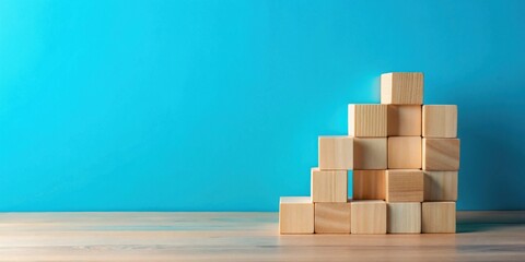 Wooden blocks arranged in an ascending pattern against a teal background