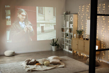 Living room with tasty snacks prepared for watching movie at home in evening