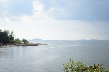 Serene Coastal Vista: A tranquil coastal panorama, with gentle waves lapping the shore beneath a sky, offering a sense of peace and expansive beauty.
