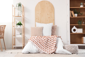 Interior of teenager's room with bed and shelf units