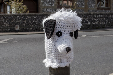 knitted white dog with black ears bollard topper in Titchfield Hampshire England