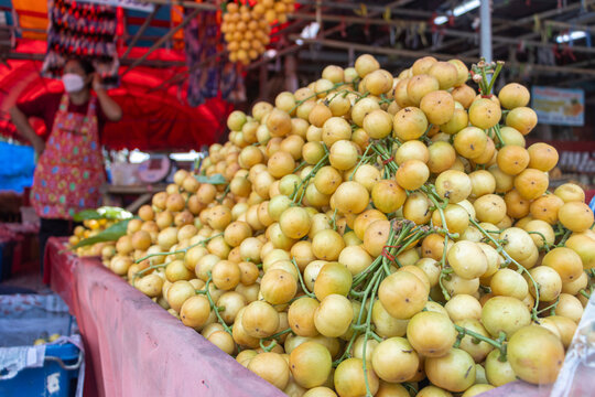 Pile of tropical fruit Burmese grapes, at the market, Thailand