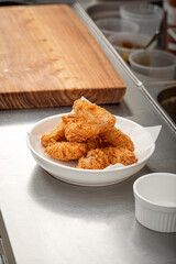 Portion of golden fried chicken in the cafe kitchen