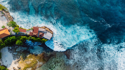 Tropical landscape with cape coastline and ocean with waves in Nusa Ceningan island, Bali. Aerial view