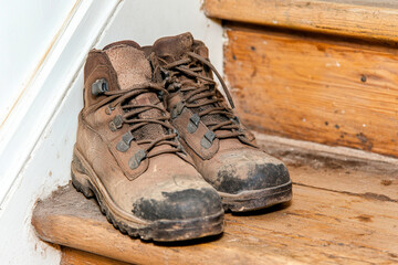 Single shoe left on an old staircase evokes a sense of chaos and forgotten stories in a dimly lit setting