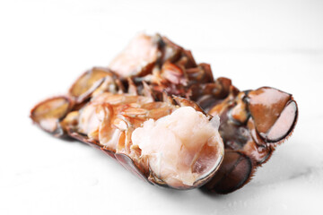 Raw lobster tails on white table, closeup