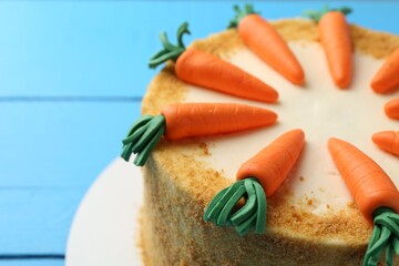 Delicious homemade carrot cake on light blue table, closeup. Space for text