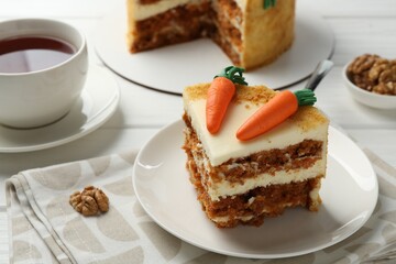 Delicious homemade carrot cake served on white wooden table