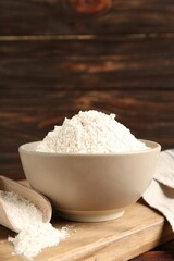 Brown rice flour on wooden table, closeup. Space for text