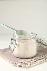 Brown rice flour on white table, closeup. Space for text