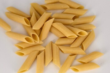 close up horizontal image of a classic italian style uncooked pasta over a white background