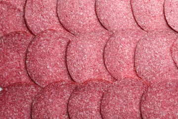 Slices of tasty smoked sausage as background, top view