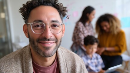 Smiling man with glasses participates in collaborative project in modern workspace with engaged colleagues
