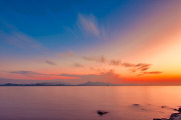 Obraz premium Sunrise Over a Calm Sea