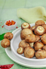 Fresh raw cremini mushrooms with spices and herbs. Healthy ingredient for cooking vegan food