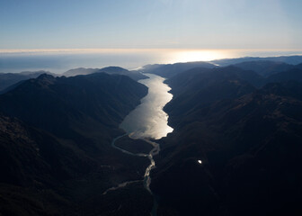 Lake McKerrow Whakatipu Waitai between Southern Alps foothill mountain valley with Southland coastline in background, untouched New Zealand landscape