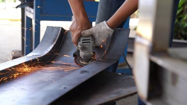 A skilled artisan uses an angle grinder to shape metal, sparks flying as the tool transforms the raw material.