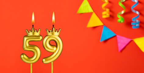 Number 59 candle - Birthday celebration on an orange background with pennants