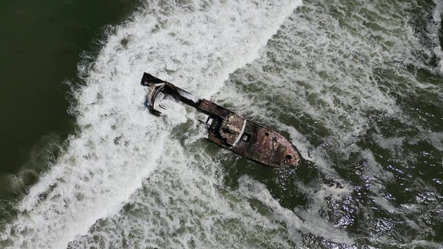 Aerial drone view of Zeila Shipwreck Namibia surrounded by foamy waves on the South Atlantic Ocean