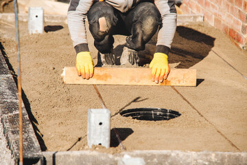 Skilled builder levels sand for new patio