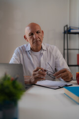 Asian businesswomen showing a bad expression while looking at graphics on a desk during a business meeting, they are feeling stressed and having problems