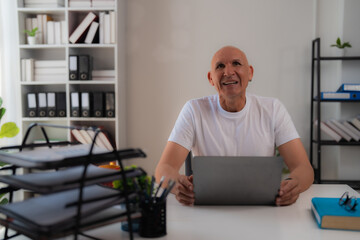 Young businesswoman is working late at night in a modern office with a tablet and a stylus. Holding...