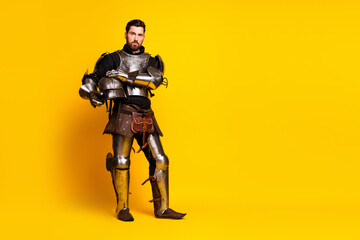 Portrait of a medieval knight in full armor with a vibrant yellow background for strong emphasis