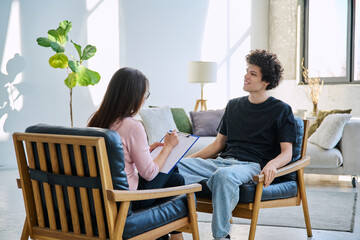 Young man in mental therapy session in office of social psychologist,counselor