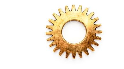 Small brass gear with natural patina lying flat on white background