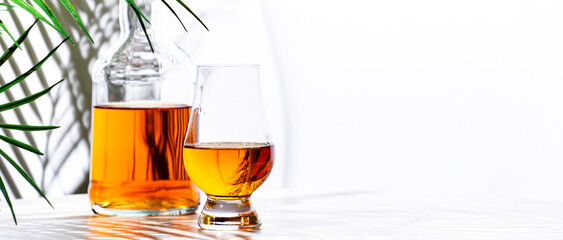Scotch whisky in glencairn glass for tasting and bottle  n white background
