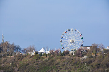 Fototapeta premium April 11, 2025 Almaty Kazakhstan. View of the Ferris wheel on Mount Koktobe.