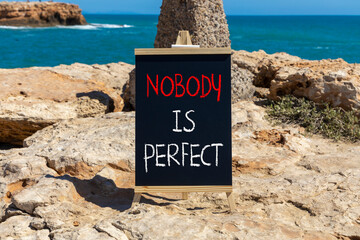 Nobody is perfect symbol. Concept words Nobody is perfect on beautiful blackboard. Beautiful brown...