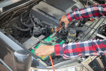 car service center mechanics are checking condition car and engine make sure they are ready use and in perfect condition according center warranty. periodic vehicle inspections for safety in driving.