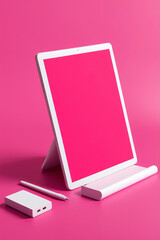 Mockup photo of the white tablet on fuchsia colored background