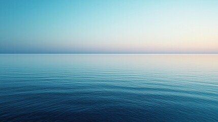 Fototapeta premium A tranquil sea stretches endlessly under a soft blend of pastel colors as the sun sets. The smooth surface of the water mirrors the gradual transition from day to night