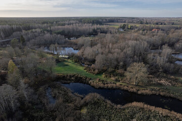 Obraz premium aerial view of forest in early spring and some water ponds in forest