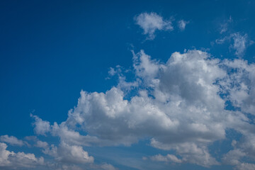 white cumulus clouds in blue sky