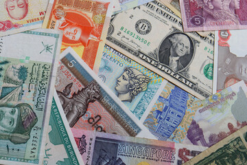 stacks of banknotes from various countries in the world