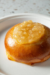 A closeup view of an apple pie bun.