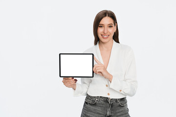 Fototapeta premium Smiling young Caucasian girl woman female student manager holding using digital tablet showing demonstrate mock up blank screen isolated on white background copy space. Technology concept