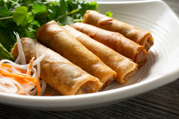 A view of a plate of egg rolls.