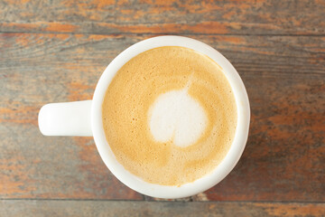 A top down view of a latte in a ceramic mug.